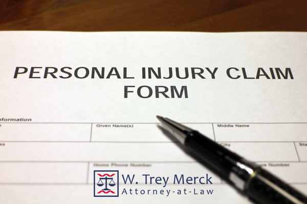 an injury claim form and a pen on a desk