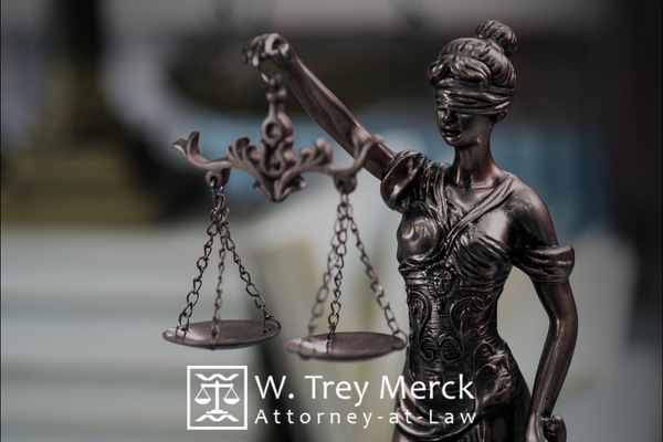 an image of a lady of justice statue on an attorneys desk